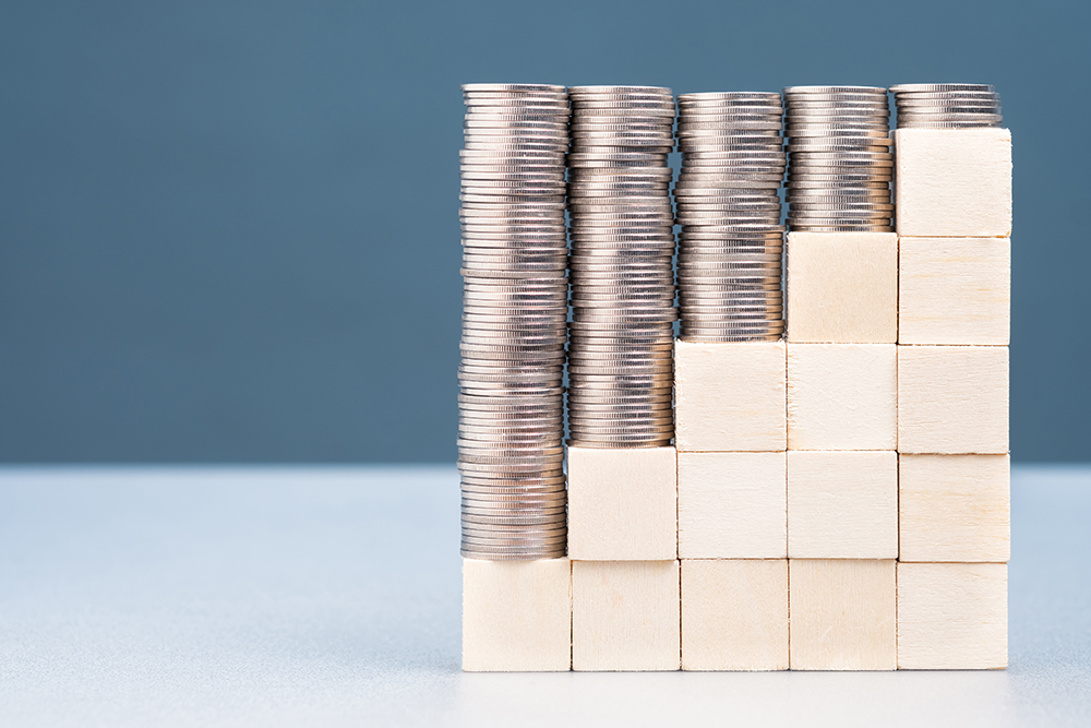 coins stacked on wood blocks